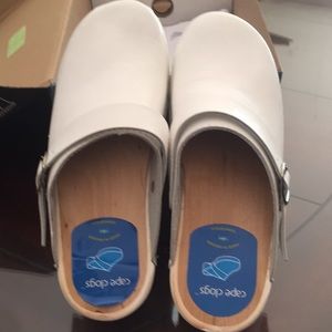 Woman’s white dansco clogs